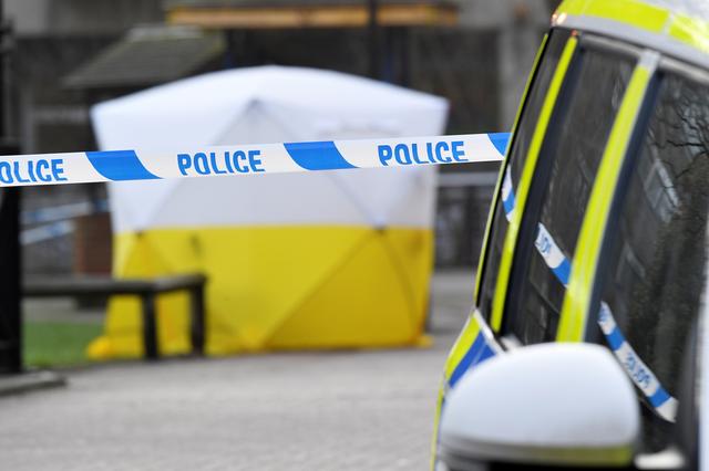 FILE PHOTO: A police car is parked next to crime scene tape, as a tent covers a park bench on which former Russian inteligence officer Sergei Skripal was found unconscious in Salisbury, Britain, March 6, 2018. REUTERS/Toby Melville/File Photo