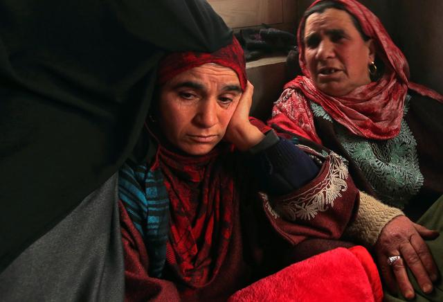 Fahmeeda (L), mother of Adil Ahmad Dar, who according to police carried out the suicide attack on the Central Reserve Police Force (CRPF) convoy and killed 44 on Thursday, sits inside her home in Gundbagh village in south Kashmir's Pulwama district, February 15, 2019. REUTERS/Danish Ismail