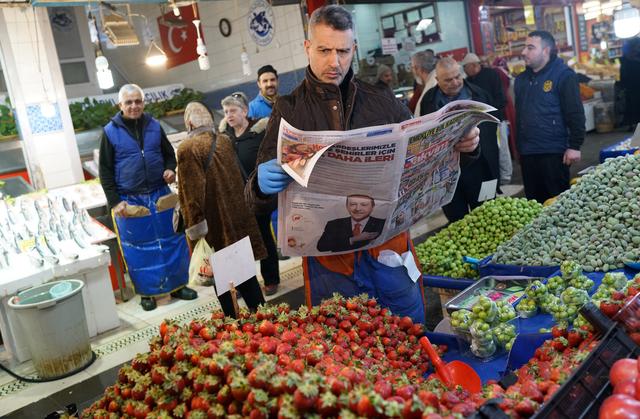 A stallholder reads a newspaper as he waits for customers at a bazaar in Ankara, Turkey, March 26, 2019. Picture taken March 26, 2019. REUTERS/Umit Bektas
