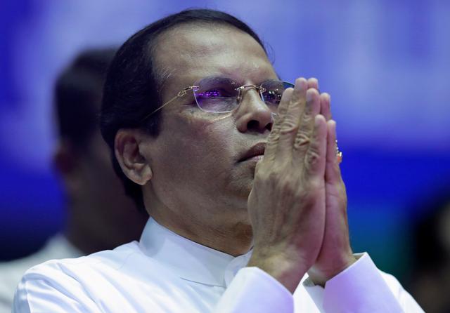FILE PHOTO: Sri Lanka's President Maithripala Sirisena prays during a special party convention in Colombo, Sri Lanka December 4, 2018. REUTERS/Dinuka Liyanawatte