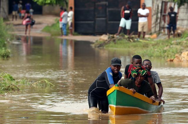 A man ferries residents through a flooded road in the aftermath of Cyclone Kenneth in Pemba, Mozambique, April 29, 2019. REUTERS/Mike Hutchings