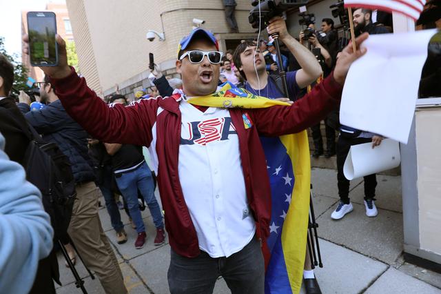 Supporters of Venezuelan opposition leader Juan Guaido celebrate outside the Venezuelan embassy to the United States after U.S. law enforcement officers arrested and removed the remaining activists sympathetic to embattled President Nicolas Maduro who had been part of a multi-week occupation of the embassy in Washington, U.S., May 16, 2019. REUTERS/Jonathan Ernst