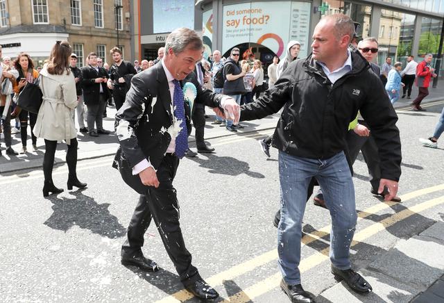 Brexit Party leader Nigel gestures after being hit with a milkshake while arriving for a Brexit Party campaign event in Newcastle, Britain, May 20, 2019. REUTERS/Scott Heppell