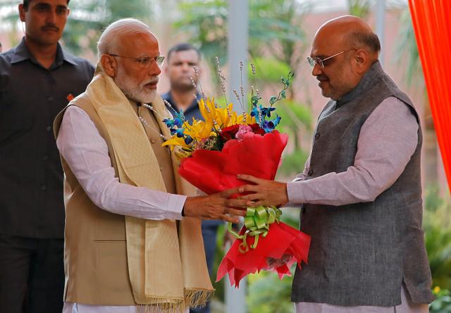 India's Prime Minister Narendra Modi receives a flower bouquet from the Bharatiya Janata Party (BJP) President Amit Shah upon his arrival to attend a thanksgiving ceremony by BJP leaders to its allies at the party headquarters in New Delhi, India, May 21, 2019. REUTERS/Anushree Fadnavis