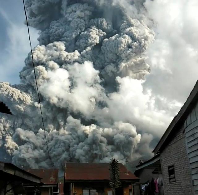 A volcanic ash cloud from Mount Sinabung hovers over Karo, North Sumatra, Indonesia June 9, 2019, in this still image taken from a social media video. Sinarisa Sitepu via REUTERS