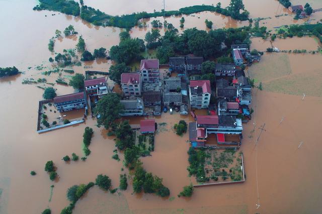 Residential houses and cars are seen submerged in floodwaters following heavy rainfall in Taihe county, Jian, Jiangxi province, China June 10, 2019. REUTERS/Stringer