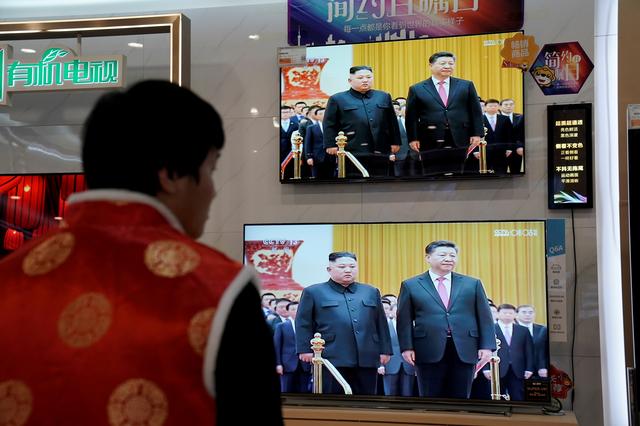 FILE PHOTO: Television screens show Chinese state media CCTV's footage of North Korean leader Kim Jong Un's meeting with Chinese President Xi Jinping, at an electronics store in Beijing, China January 10, 2019. REUTERS/Jason Lee/File Photo