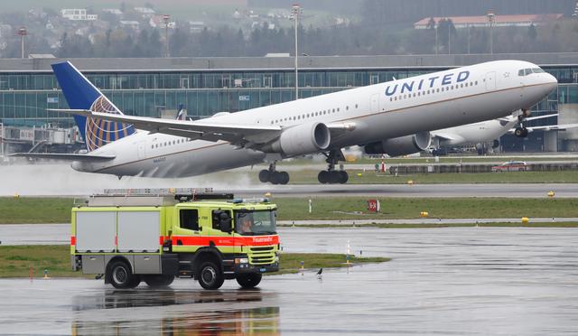 FILE PHOTO: A vehicle of the airport rescue and firefighting services stands in front as a Boeing 767-400ER aircraft of United Airlines takes off from Zurich airport, April 9, 2019.  REUTERS/Arnd Wiegmann