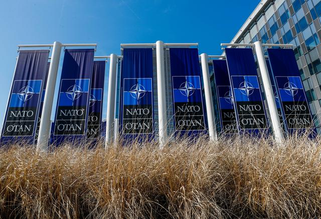Banners displaying the NATO logo are placed at the entrance of new NATO headquarters during the move to the new building, in Brussels, Belgium April 19, 2018.  REUTERS/Yves Herman