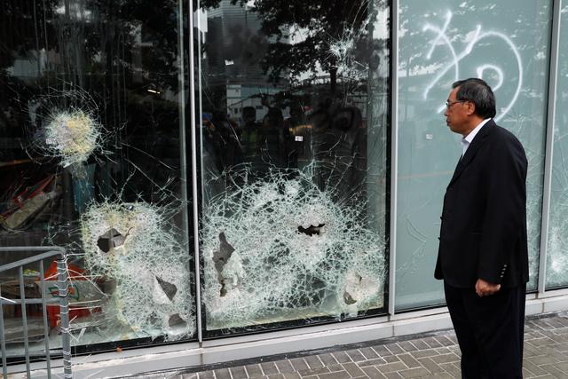  Andrew Leung, president of the Legislative Council, looks at damaged glass panels, a day after protesters broke into the council building, in Hong Kong, China July 2, 2019.  REUTERS/Jorge Silva