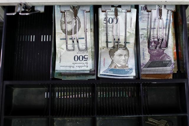 Venezuelan bolivar notes are pictured in an open cash register at a parking lot in Caracas, Venezuela May 29, 2018. REUTERS/Marco Bello