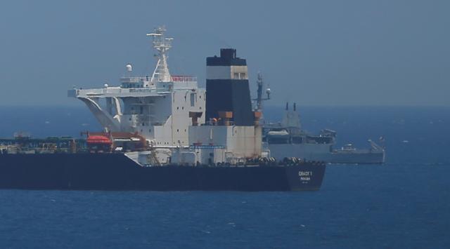 A British Royal Navy patrol vessel guards the oil supertanker Grace 1, that's on suspicion of carrying Iranian crude oil to Syria, as it sits anchored in waters of the British overseas territory of Gibraltar, historically claimed by Spain, July 4, 2019. REUTERS/Jon Nazca