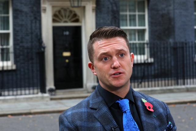 FILE PHOTO: Far right activist Stephen Yaxley-Lennon, who goes by the name Tommy Robinson, speaks outside 10 Downing Street after handing in a petition on behalf of a serving soldier who was disciplined for posing for a selfie with him, in London, Britain, November 6, 2018. REUTERS/Simon Dawson