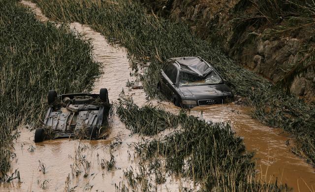 Cars are seen in the river bank after heavy rainfall in Tafalla, Spain, July 9, 2019. REUTERS/Susana Vera