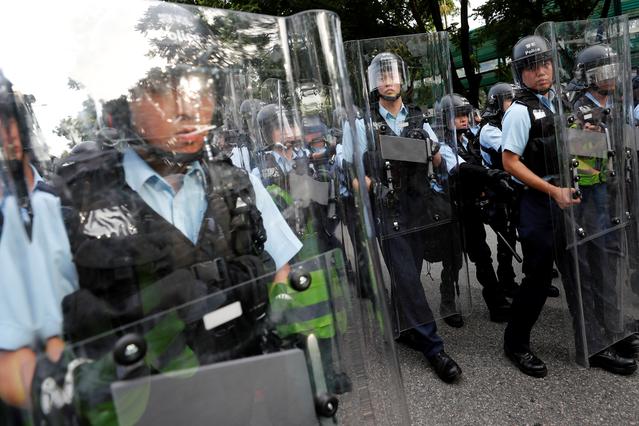 Riot police stand guard during a march at Sheung Shui, a border town in Hong Kong, China July 13, 2019. REUTERS/Tyrone Siu
