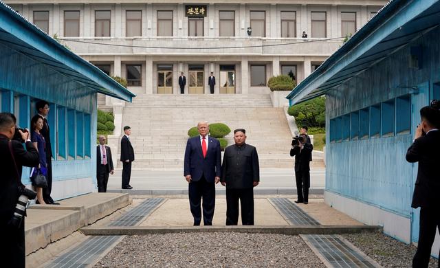 FILE PHOTO: U.S. President Donald Trump and North Korean leader Kim Jong Un stand at the demarcation line in the demilitarized zone separating the two Koreas, in Panmunjom, South Korea, June 30, 2019. REUTERS/Kevin Lamarque/File Photo