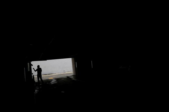 A man walks at parking garage during a blackout in Caracas, Venezuela July 22, 2019. REUTERS/Carlos Garcia Rawlins