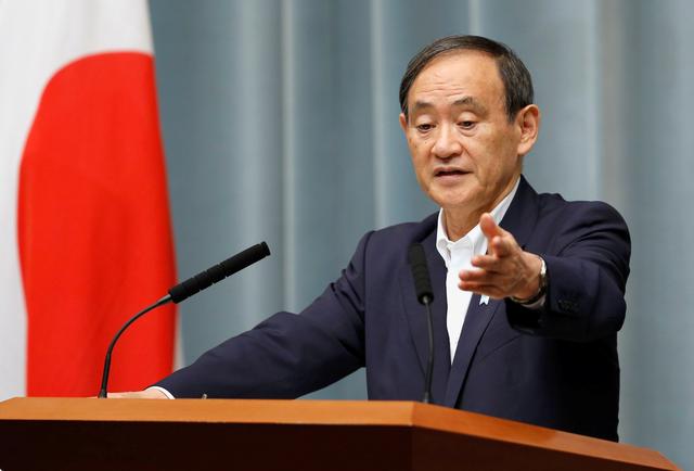 FILE PHOTO: Japan's Chief Cabinet Secretary Yoshihide Suga attends a news conference at Prime Minister Shinzo Abe's official residence in Tokyo, Japan May 29, 2017.   REUTERS/Toru Hanai/File Photo