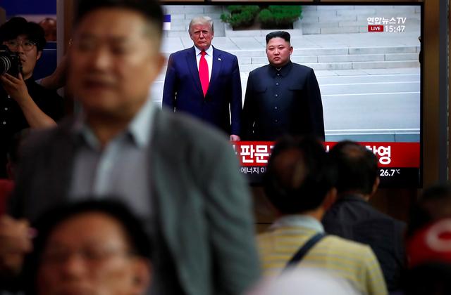 FILE PHOTO: South Korean people watch a live TV broadcast on a meeting between North Korean leader Kim Jong Un and U.S. President Donald Trump at the truce village of Panmunjom inside the demilitarised zone separating the two Koreas, in Seoul, South Korea, June 30, 2019. REUTERS/Kim Hong-Ji/File Photo