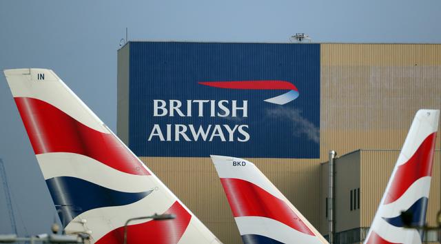 FILE PHOTO: British Airways logos on aircraft tail fins at Heathrow Airport in west London, Britain, February 23, 2018. REUTERS/Hannah McKay/File Photo
