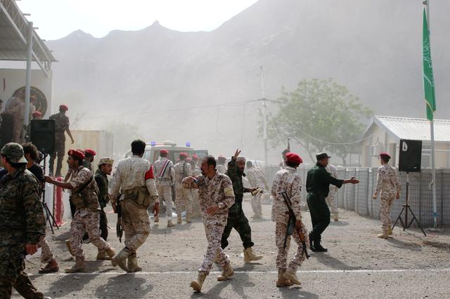 FILE PHOTO: Soldiers rush to help the injured following a missile attack on a military parade during a graduation ceremony for newly recruited troopers in Aden, Yemen August 1, 2019. REUTERS/Fawaz Salman/File Photo