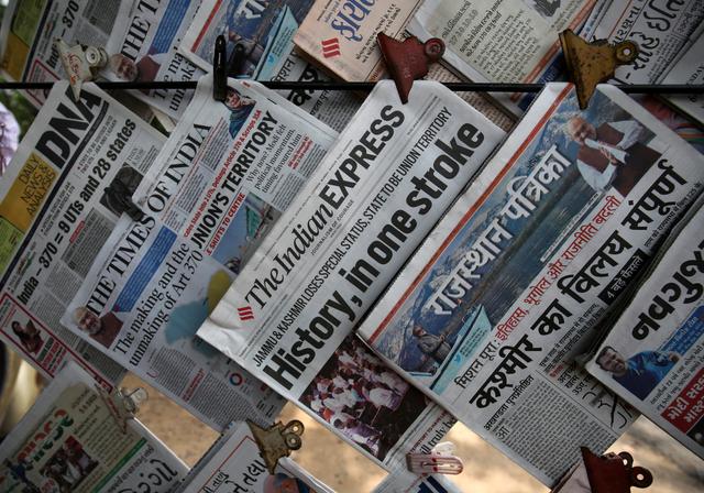 Newspapers, with headlines about Prime Minister Narendra Modi's decision to revoke special status for the disputed Kashmir region, are displayed for sale at a pavement in Ahmedabad, India, August 6, 2019. REUTERS/Amit Dave