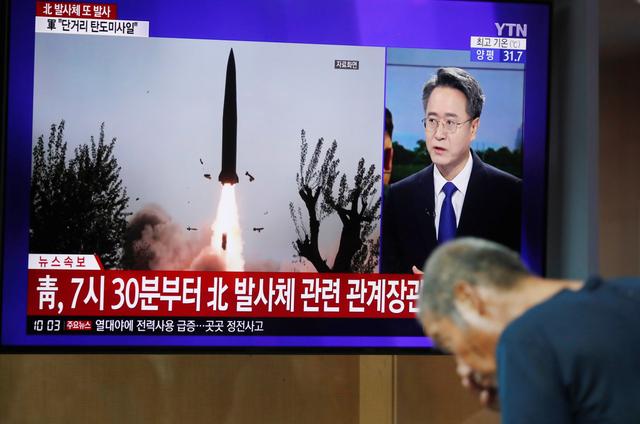 A man watches a TV showing a file picture for a news report on North Korea firing two unidentified projectiles, in Seoul, South Korea, August 6, 2019.    REUTERS/Kim Hong-Ji