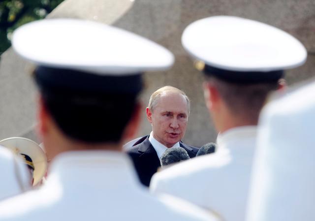 FILE PHOTO: Russian President Vladimir Putin addresses the troops during the military parade during the Navy Day celebration in St.Petersburg, Russia, July 28, 2019. Dmitri Lovetsky/Pool via REUTERS/File Photo