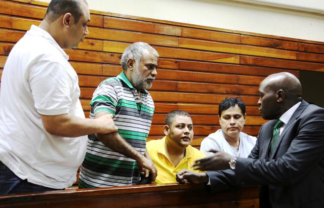 FILE PHOTO: (L-R) Baktash Akasha, Gulam Hussein, Ibrahim Akasha and Vijaygiri Goswami are briefed by their lawyer Cliff Ombeta at Mombasa Law Courts during a court appearance on drug-related charges in Mombasa February 17, 2015.  REUTERS/Joseph Okanga/File Photo