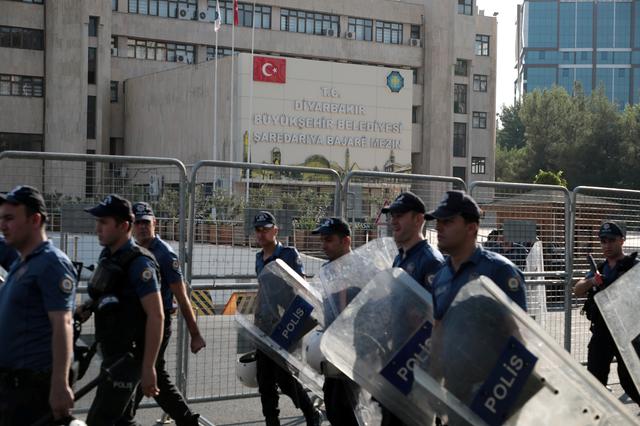 Turkish police walk in front of the Metropolitan Municipality headquarters in Diyarbakir, Turkey, August 19, 2019. REUTERS/Murad Sezer