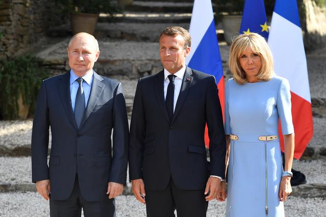 French President Emmanuel Macron and his wife Brigitte Macron pose with Russia's President Vladimir Putin, at the French President's summer retreat of the Bregancon fortress on the Mediterranean coast, near the village of Bormes-les-Mimosas, southern France, on August 19, 2019. Gerard Julien/Pool via REUTERS