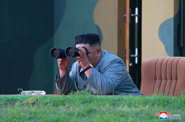FILE PHOTO: North Korean leader Kim Jong Un watches the test-fire of two short-range ballistic missiles on Thursday, in this undated picture released by North Korea's Central News Agency (KCNA) on July 26, 2019.  KCNA/via REUTERS 