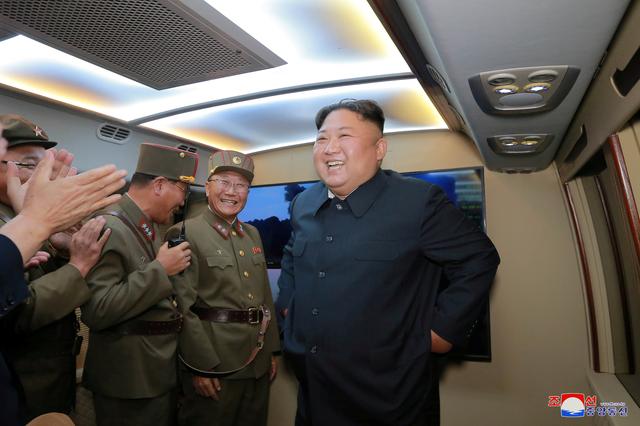 FILE PHOTO: North Korean leader Kim Jong Un smiles as he guides missile testing at an unidentified location in North Korea, in this undated image provided by KCNA on August 7, 2019.  KCNA via REUTERS