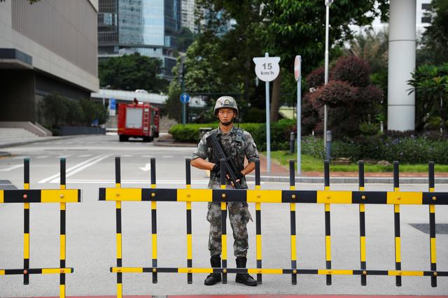 A Chinese People's Liberation Army (PLA) soldier guards the entrance to the PLA Hong Kong Garrison headquarters in the Central Business District in Hong Kong, China, August 29, 2019. REUTERS/Anushree Fadnavis