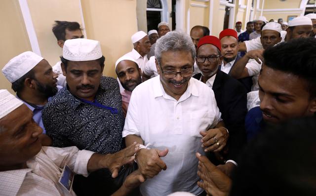 Sri Lanka's former wartime defense secretary and presidential candidate Gotabaya Rajapaksa shares a moment with Muslims during his visit at Ketchimale mosque in Beruwala, Sri Lanka August 17, 2019. REUTERS/Dinuka Liyanawatte