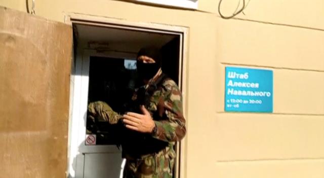 A still image taken from a video footage shows a masked law enforcement officer addressing journalists during a raid in a local office of Kremlin critic Alexei Navalny in Perm, Russia September 12, 2019. 59.RU/Handout via REUTERS TV  