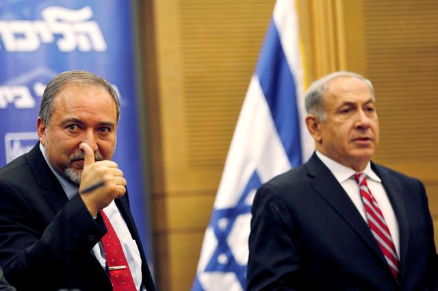 FILE PHOTO: Israel's Prime Minister Benjamin Netanyahu (R) and Avigdor Lieberman attend a Likud-Beitenu faction meeting at the Knesset, the Israeli parliament, in Jerusalem November 11, 2013. REUTERS/Amir Cohen/File Photo