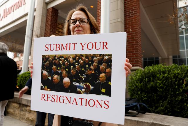 FILE PHOTO: Anne Barrett Doyle, co-director of BishopAccountability.org, holds a sign during the protest outside the venue of the United States Conference of Catholic Bishops (USCCB) general assembly in Baltimore, Maryland, U.S., November 12, 2018. REUTERS/Kevin Lamarque/File Photo