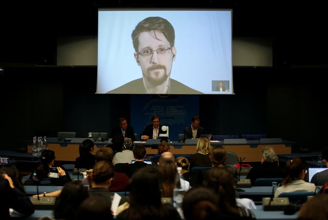 FILE PHOTO - Edward Snowden speaks via video link as he takes part in a round table on the protection of whistleblowers at the Council of Europe in Strasbourg, France, March 15, 2019.   REUTERS/Vincent Kessler
