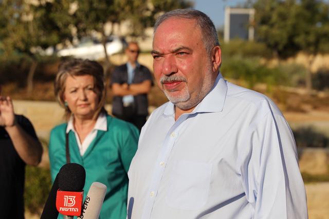 Avigdor Lieberman, leader of Yisrael Beitenu party, stands next to his wife Ella as he speaks to members of the media after casting his ballot in Israel's parliamentary election, at a polling station in the Israeli settlement of Nokdim in the occupied West Bank September 17, 2019. REUTERS/Ammar Awad