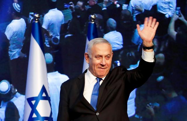 Israeli Prime Minister Benjamin Netanyahu waves as he arrives at the Likud party headquarters following the announcement of exit polls during Israel's parliamentary election in Tel Aviv, Israel September 18, 2019. REUTERS/Ammar Awad