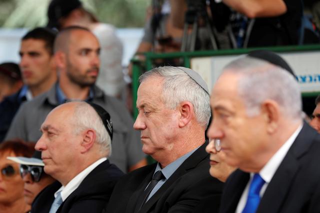 Benny Gantz, leader of Blue and White party, looks on as he sits next to Israeli Prime Minister Benjamin Netanyahu during a memorial ceremony for late Israeli President Shimon Peres, at Mount Herzl in Jerusalem September 19, 2019. REUTERS/Ronen Zvulun
