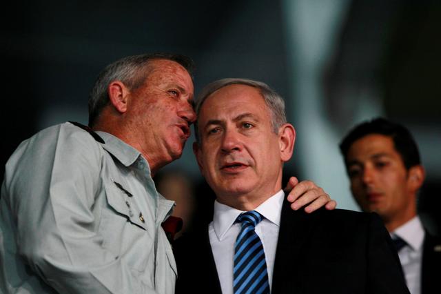 FILE PHOTO: Israel's Prime Minister Benjamin Netanyahu (R) and Israel's armed forces chief Major-General Benny Gantz speak during the opening ceremony of the 19th Maccabiah Games at Teddy Stadium in Jerusalem July 18, 2013. REUTERS/Baz Ratner