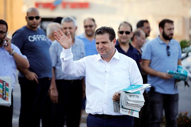 FILE PHOTO: Ayman Odeh, leader of the Joint List, gestures as he hands out pamphlets during an an election campaign event in Tira, northern Israel September 5, 2019. REUTERS/Amir Cohen