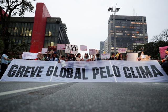 People hold a banner as they participate in the Global Climate Strike of the Fridays for Future movement in Sao Paulo, Brazil September 20, 2019. The banner reads: Global strike for climate. REUTERS/Nacho Doce