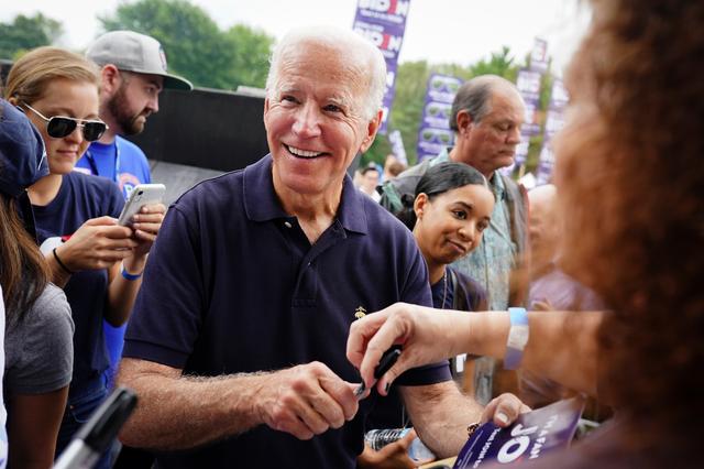 Joe Biden, former U.S. vice president and Democratic presidential hopeful, smiles while signing autographs at the Polk County Democrats' Steak Fry in Des Moines, Iowa, U.S., September 21, 2019.   REUTERS/Elijah Nouvelage