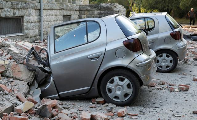 Destroyed cars stand next to a damaged building after an earthquake in Tirana, Albania, September 21, 2019. REUTERS/Florion Goga