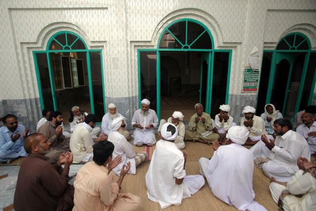 People and relatives offer condolence for eight-year-old Muhammad Faizan, who according to police was missing and his body found along with two other children, at a local mosque in Chunian, Kasur, Pakistan, September 19, 2019. Picture taken September 19, 2019.REUTERS/Mohsin Raza