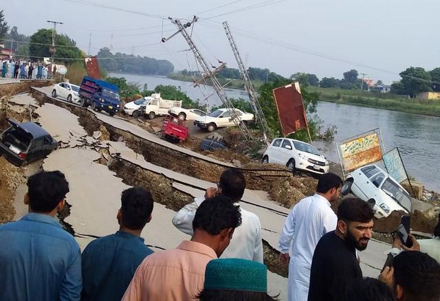 People gather near a damaged road after an earthquake of magnitude 5.8 in Mirpur, Pakistan September 24, 2019. REUTERS/Stringer