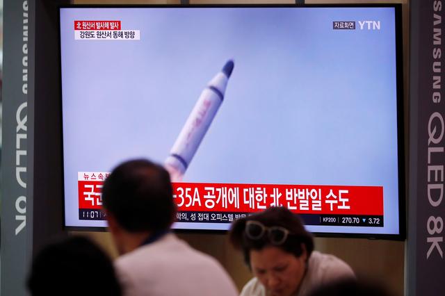 People watch a TV screening of a file footage for a news report on North Korea firing a missile that is believed to be launched from a submarine, in Seoul, South Korea, October 2, 2019. REUTERS/Kim Hong-Ji